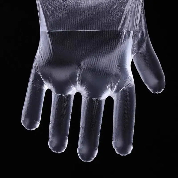 An image showing a disposable plastic glove filled half way with water to show its non-porous nature on a black background