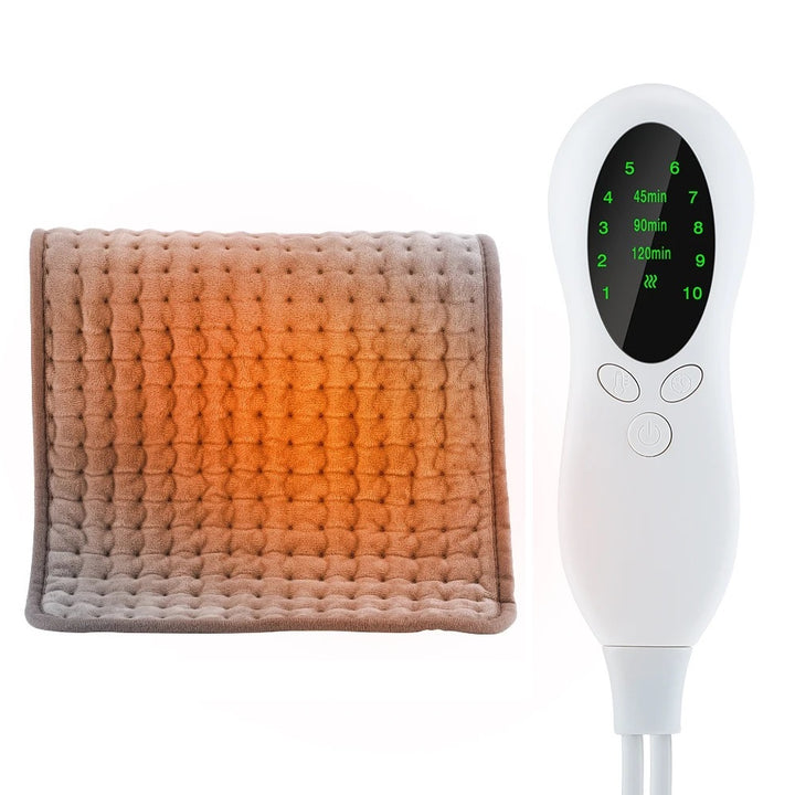 The image shows a gray electric heating pad with a white LCD digital remote control. The heating pad has a soft, plush texture with an orange glow representing the warmth, and the digital remote displays 10 various heat settings and 4 time settings with 3 buttons