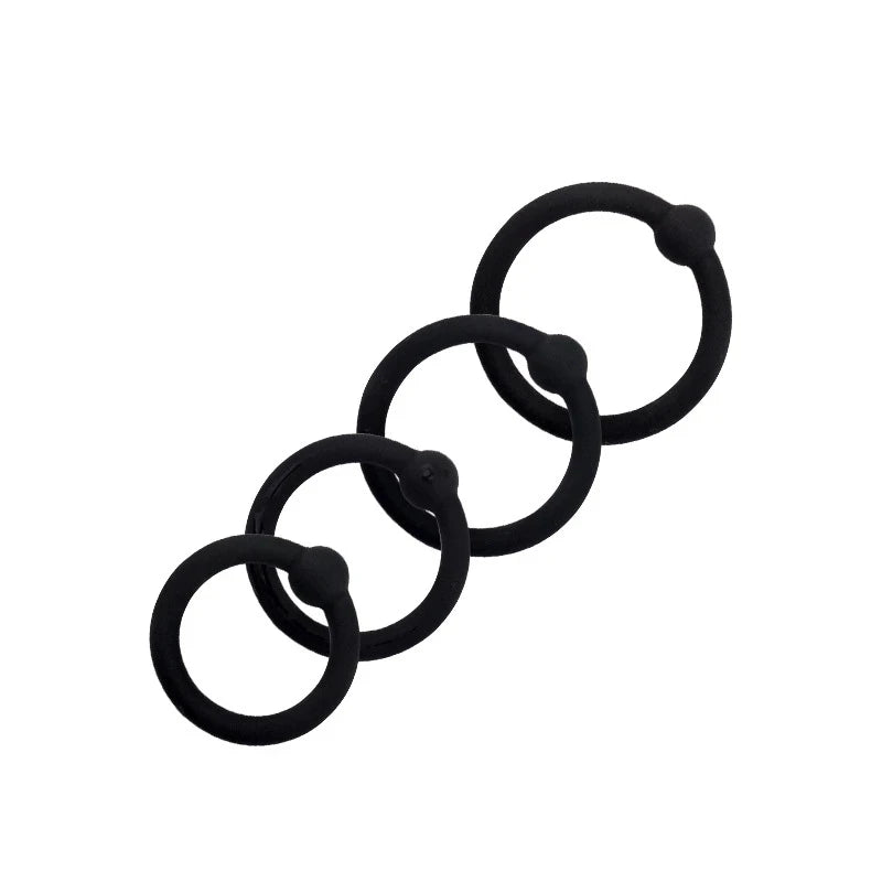 Four single-bead cock rings lying on top of each other in a diagonal line from smallest to largest