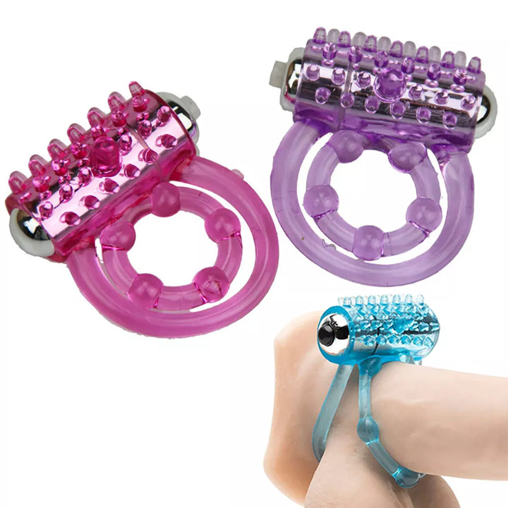 An image showing three vibrating cock rings with double bands. Two are placed by themselves, and the third is attached around a penis with the double attachment straddling the balls, showing how to wear the device.