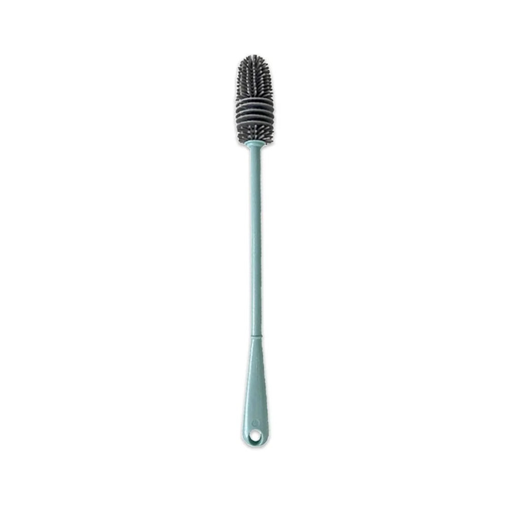 An image of a teal colored silicone cleaning brush with a long handle and soft bristle cleaning head