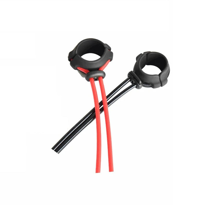 Two adjustable cock rings lying on top of each other. One has a black comfort padding and red cords, and the other is all black