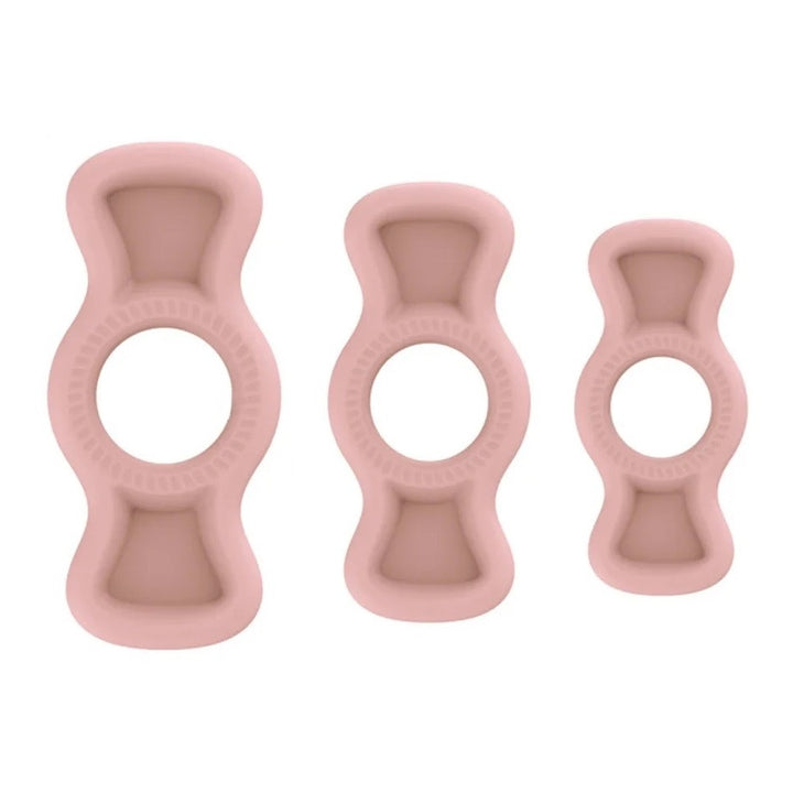 An image of three pink flesh colored silicone premium cock rings with pullable side tabs. The cock rings have small grooves for breathability, embossed tabs for easy grip, and are made of a soft and hygienic medical silicone material.