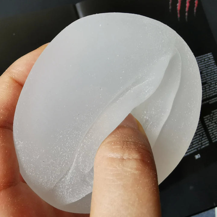 An image showing the texture of the premium pleasure penis pump sleeve with a man holding and touching the materials