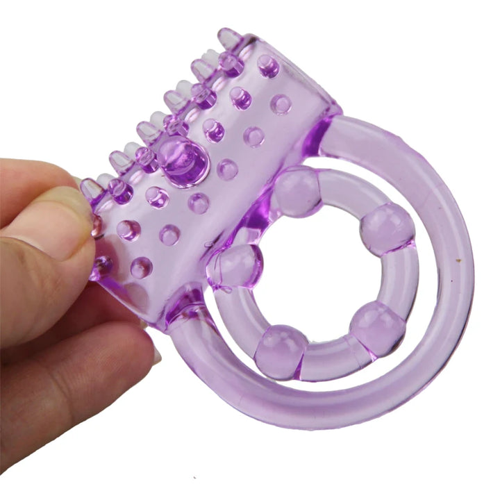 Image of a transparent purple cock ring with a double ring attachment. The outer band has a textured layer for added stimulation.