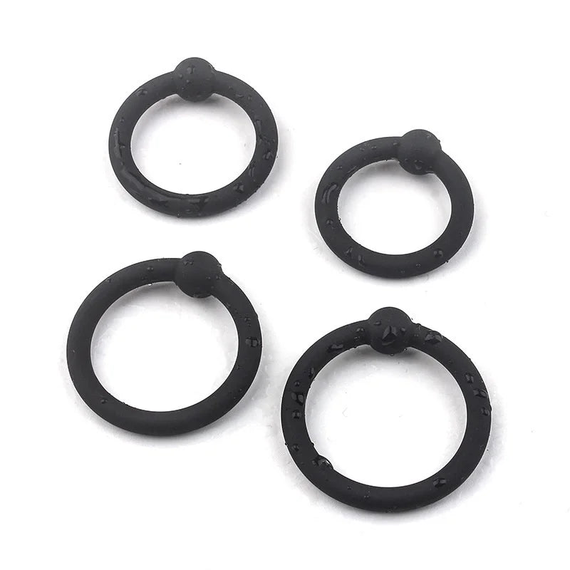 An image showing the four single bead cock rings with water on them to show that they're waterproof