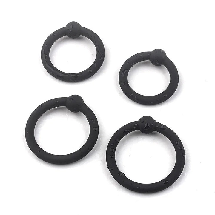 An image showing the four single bead cock rings with water on them to show that they're waterproof
