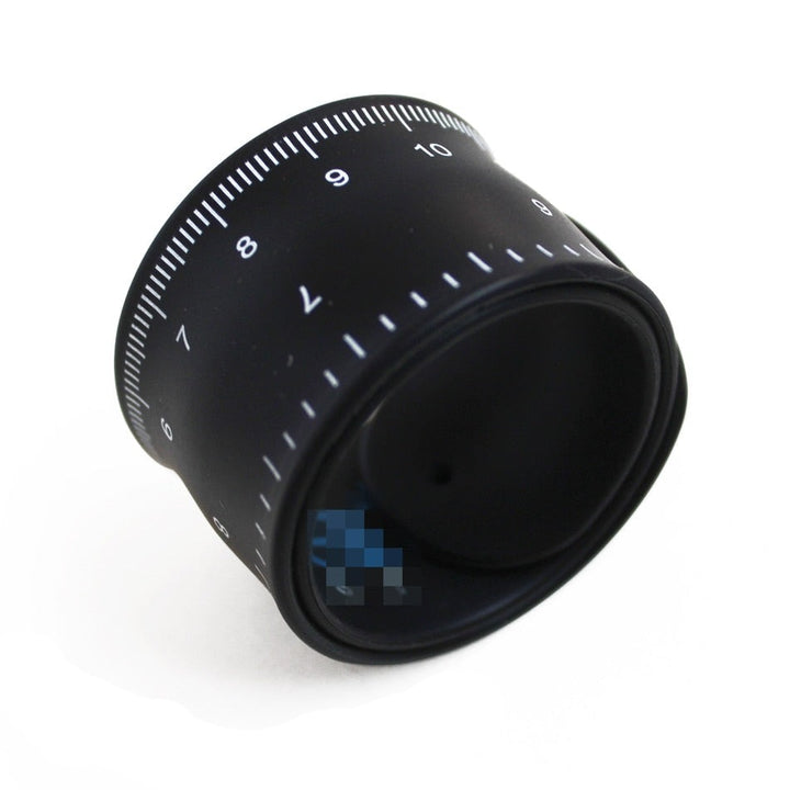 A black rolled up soft ruler with measurements on the sides