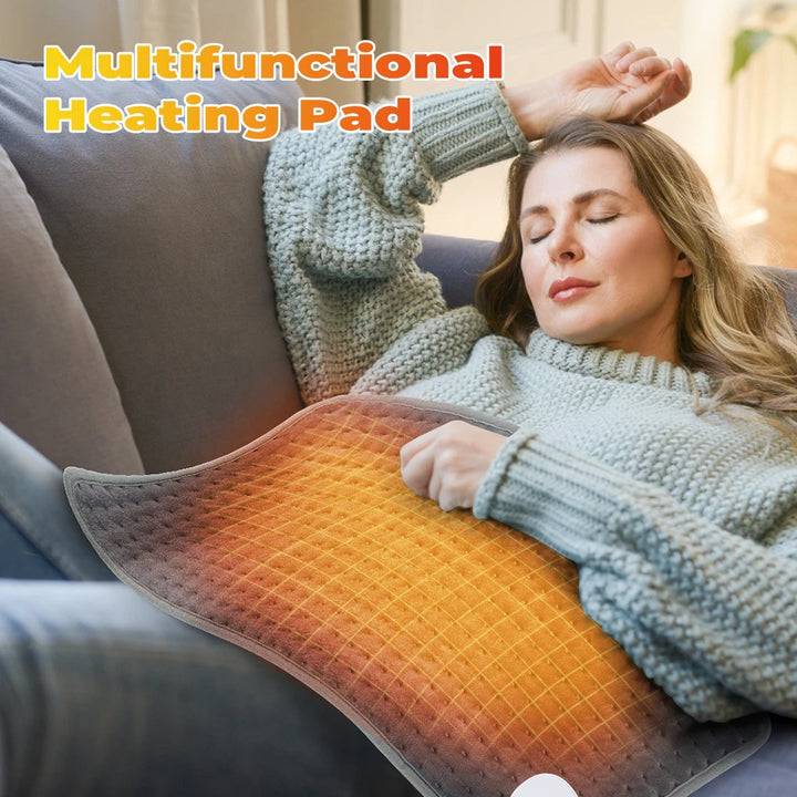 An image showing a woman sleeping on a couch with the electric heating pad on her stomach covering her and providing warmth