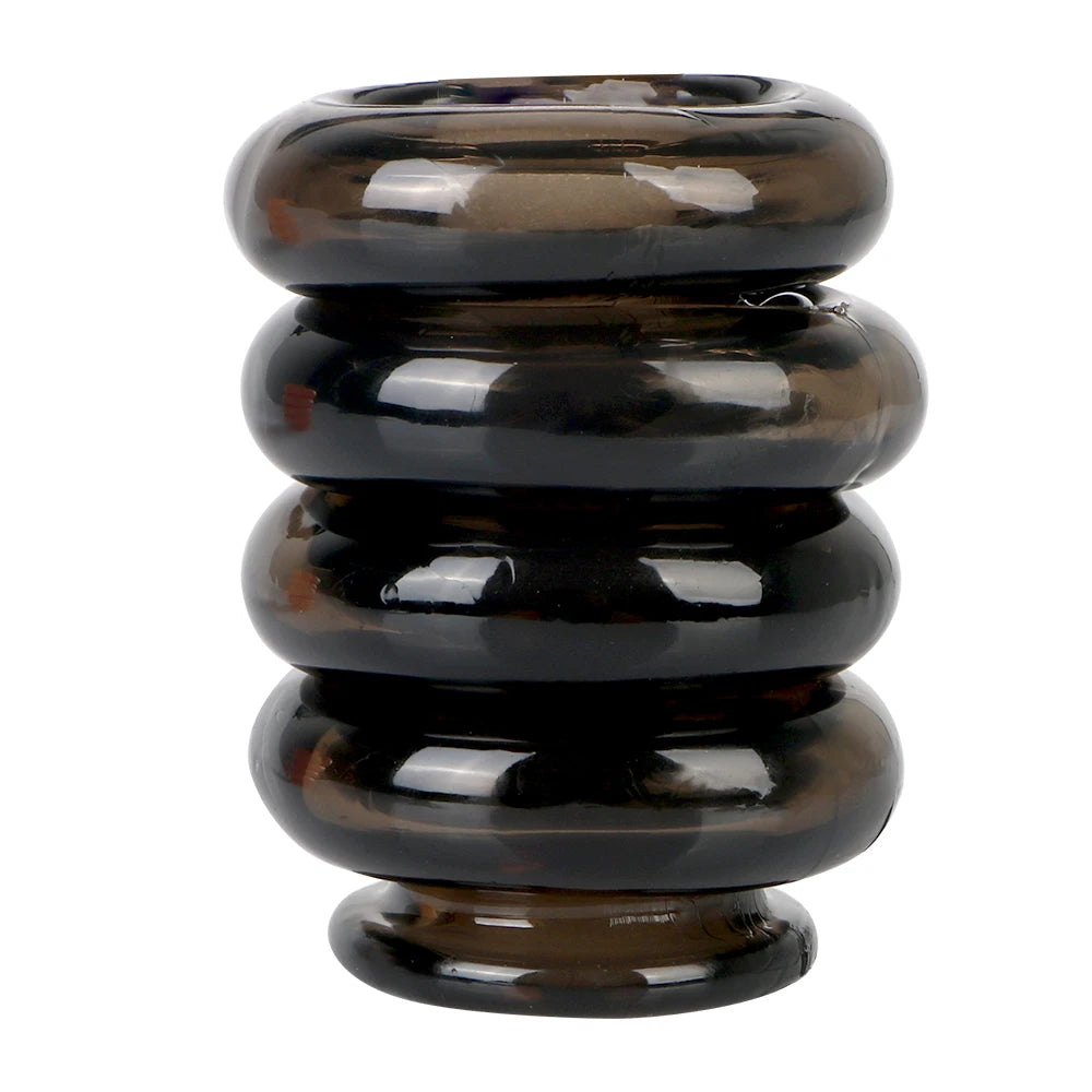 This image shows four black silicone interlocking cock rings in a vertical stack on a white background