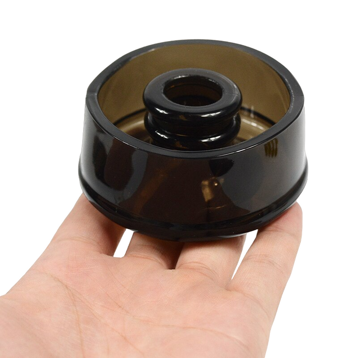 A black silicone sleeve cover being held upside down in a man's hand to show it's inside and relative size
