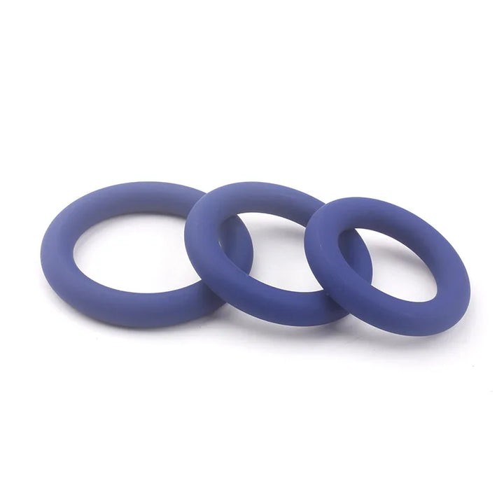 This image shows a pack of three blue cylindrical cock rings on a white background of varying sizes of small, medium, and large