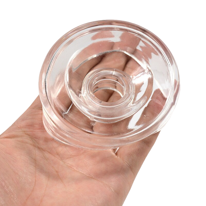 A transparent silicone sleeve cover being held in a man's hand to show its relative size.