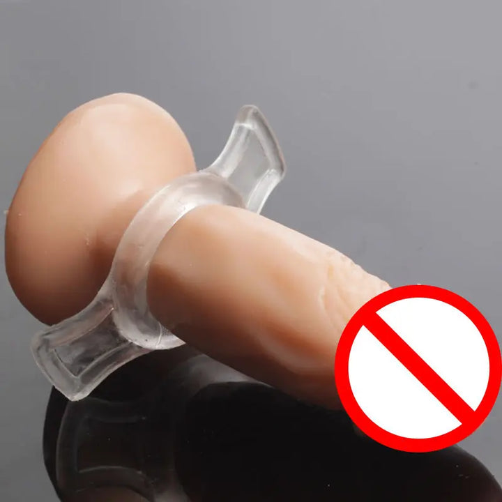An image showing a clear cock ring with pullable side tabs around the base of a fake penis replica to show how it's used