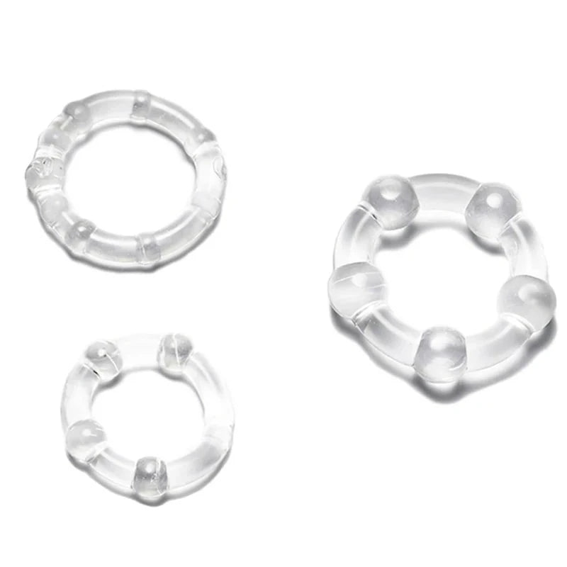 A set of three clear transparent silicone multi-ridge cock rings on a white background
