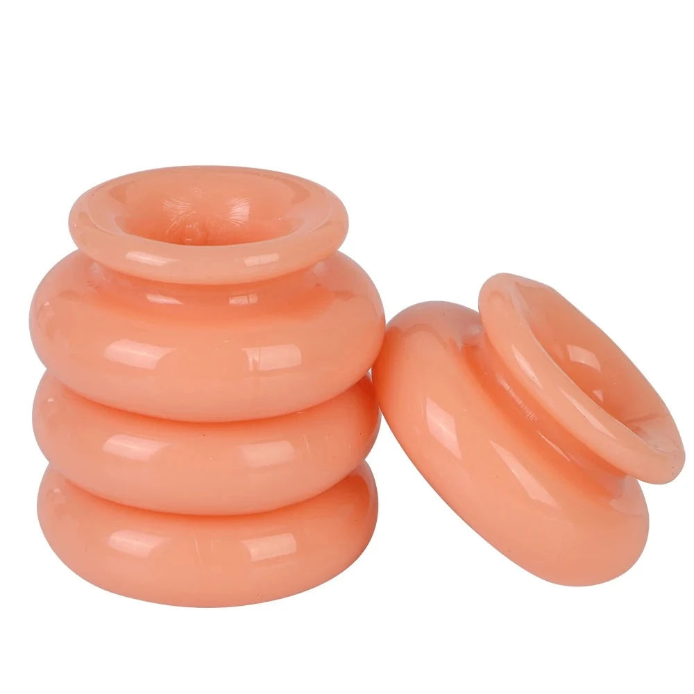 An image showing how to assemble the interlocking cock rings with one flesh colored interlocking cock ring separate from a stack of three