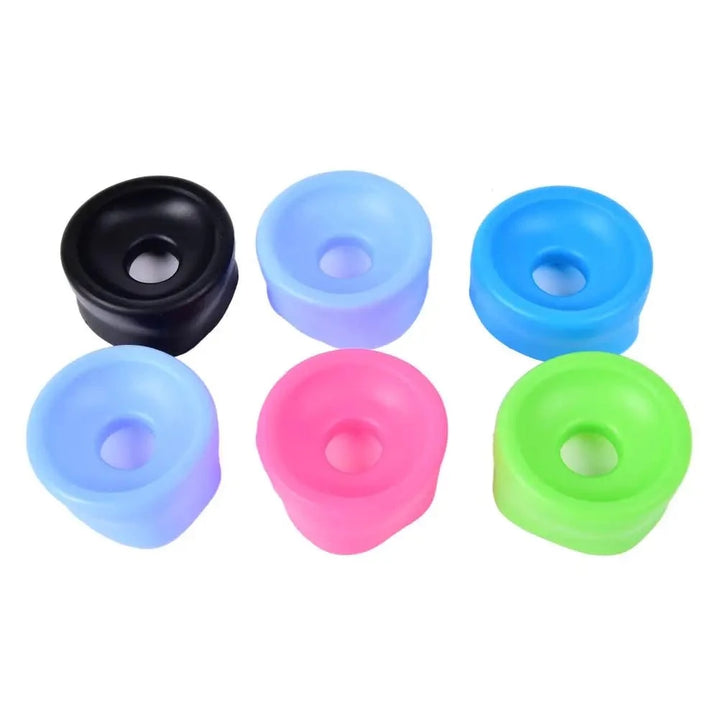 An image showing six various color coded penis pump sleeve covers on a white background