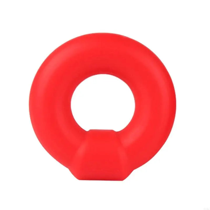 Red silicone rubber constriction ring with a geometric shape buckle on a white background