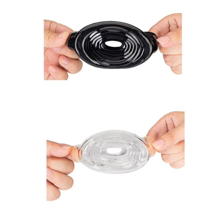 An image showing a black and white ribbed texture penis pump sleeve being pulled at the ends to show its stretchiness and flexibility