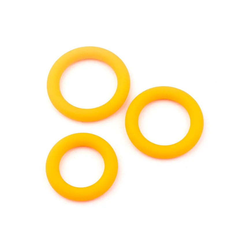 This image shows three tangerine orange color coded constriction bands for penis enlargement
