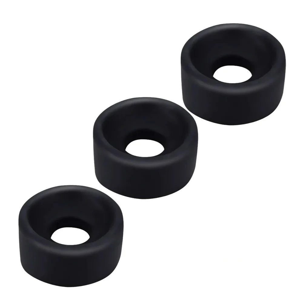 Three black silicone sleeve covers for penis pumps, displayed as a thin cylindrical ring shape with varying diameters.