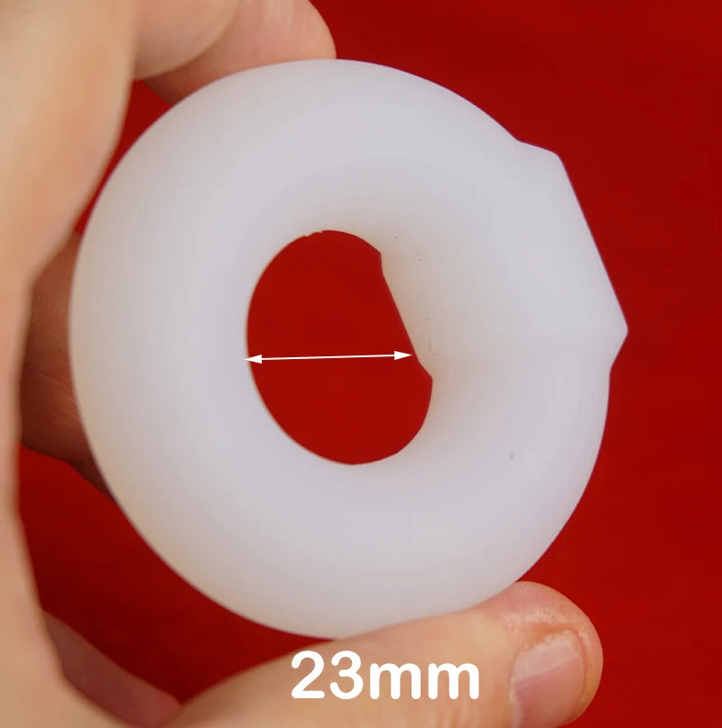 White silicone constriction band with a measurement label '23mm' on a red background